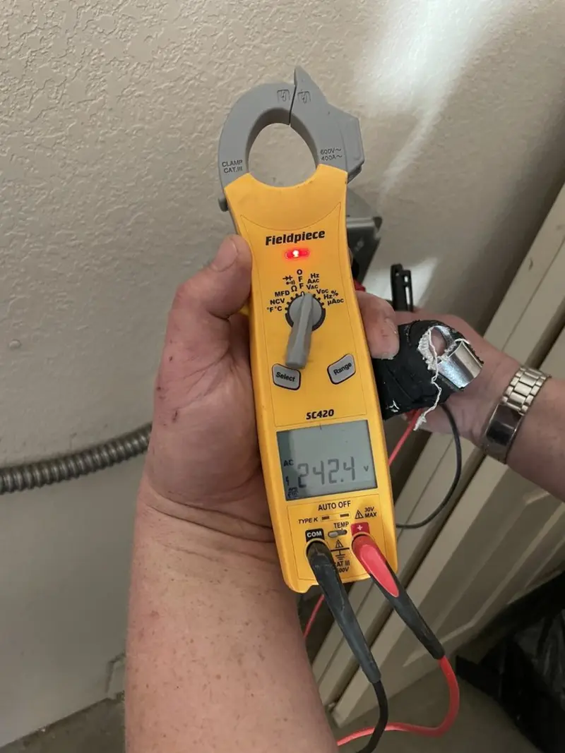 Voltage testing with clamp meter during Electrical Installation Services in Boonville
